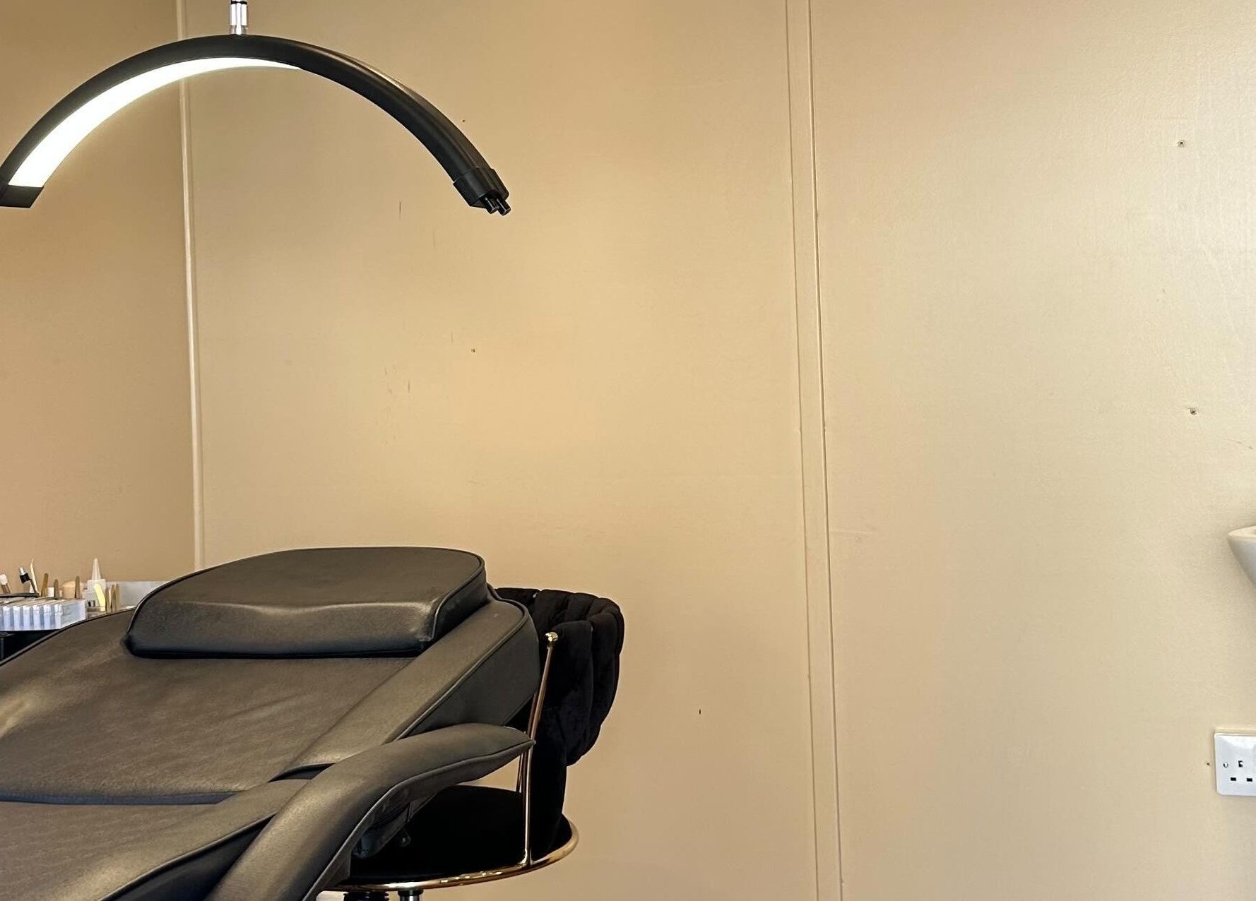 Luxurious treatment room at The Glow Hub, Black Notley, England. Elegant decor with a cozy reclining chair.