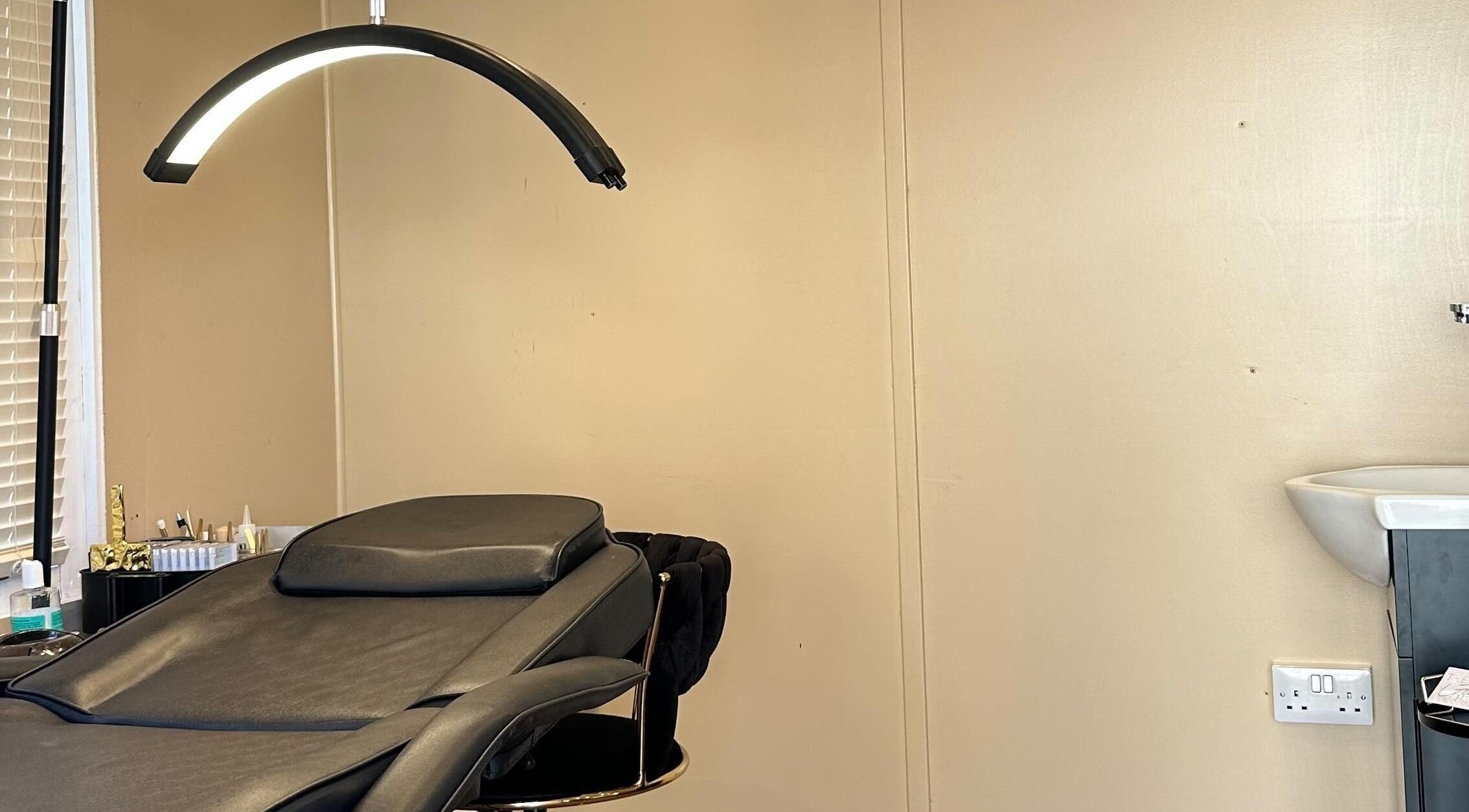 Luxurious treatment room at The Glow Hub, Black Notley, England. Elegant decor with a cozy reclining chair.