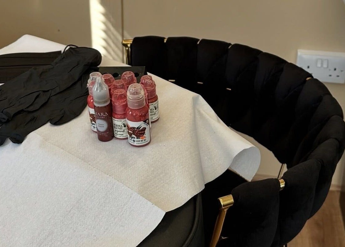 Beauty supplies on a chair at The Glow Hub, Black Notley, England, GB. Includes gloves and pigment bottles.