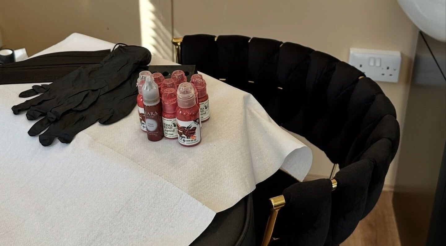 Beauty supplies on a chair at The Glow Hub, Black Notley, England, GB. Includes gloves and pigment bottles.