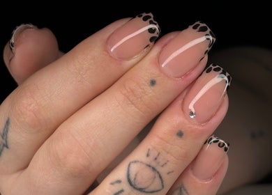 Elegant nail art featuring black patterns at Be Beautiful by Gee, Cheltenham, England, GB.