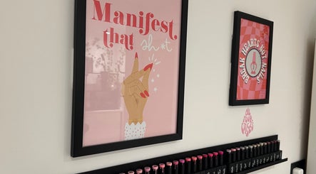 Decorative nail art posters at Cured by Beth, Edinburgh, Scotland, GB, showcasing creative salon wall designs.