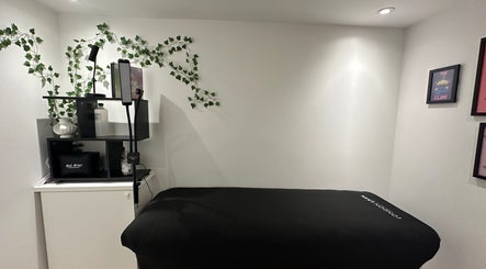 Relaxing treatment room at Cured by Beth, Edinburgh, Scotland, GB with calming decor and cozy massage bed.