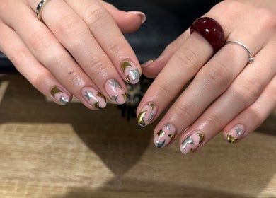 Starry nail art design at Cured by Beth in Edinburgh, Scotland, GB showcases gold and silver stars.