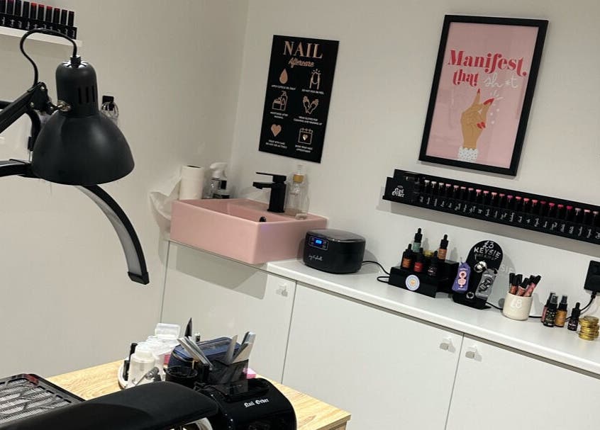Elegant nail station at Cured by Beth, Edinburgh, Scotland, GB, showcasing a stylish pink sink and decor.