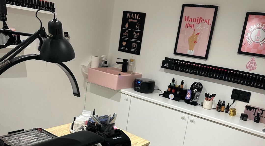 Elegant nail station at Cured by Beth, Edinburgh, Scotland, GB, showcasing a stylish pink sink and decor.