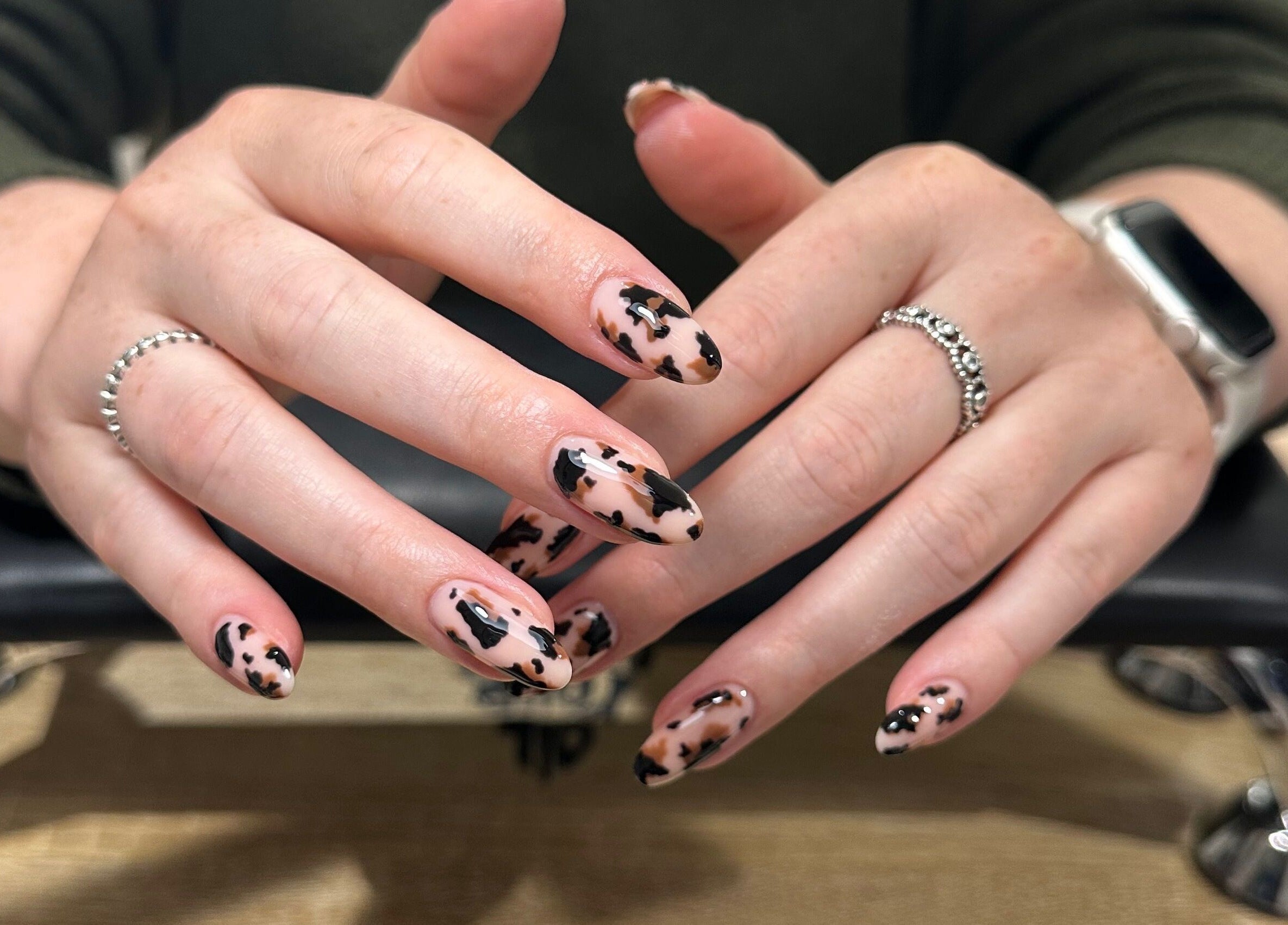 Stylish nail art design at Cured by Beth, Edinburgh, Scotland, GB, featuring black and pink patterns.