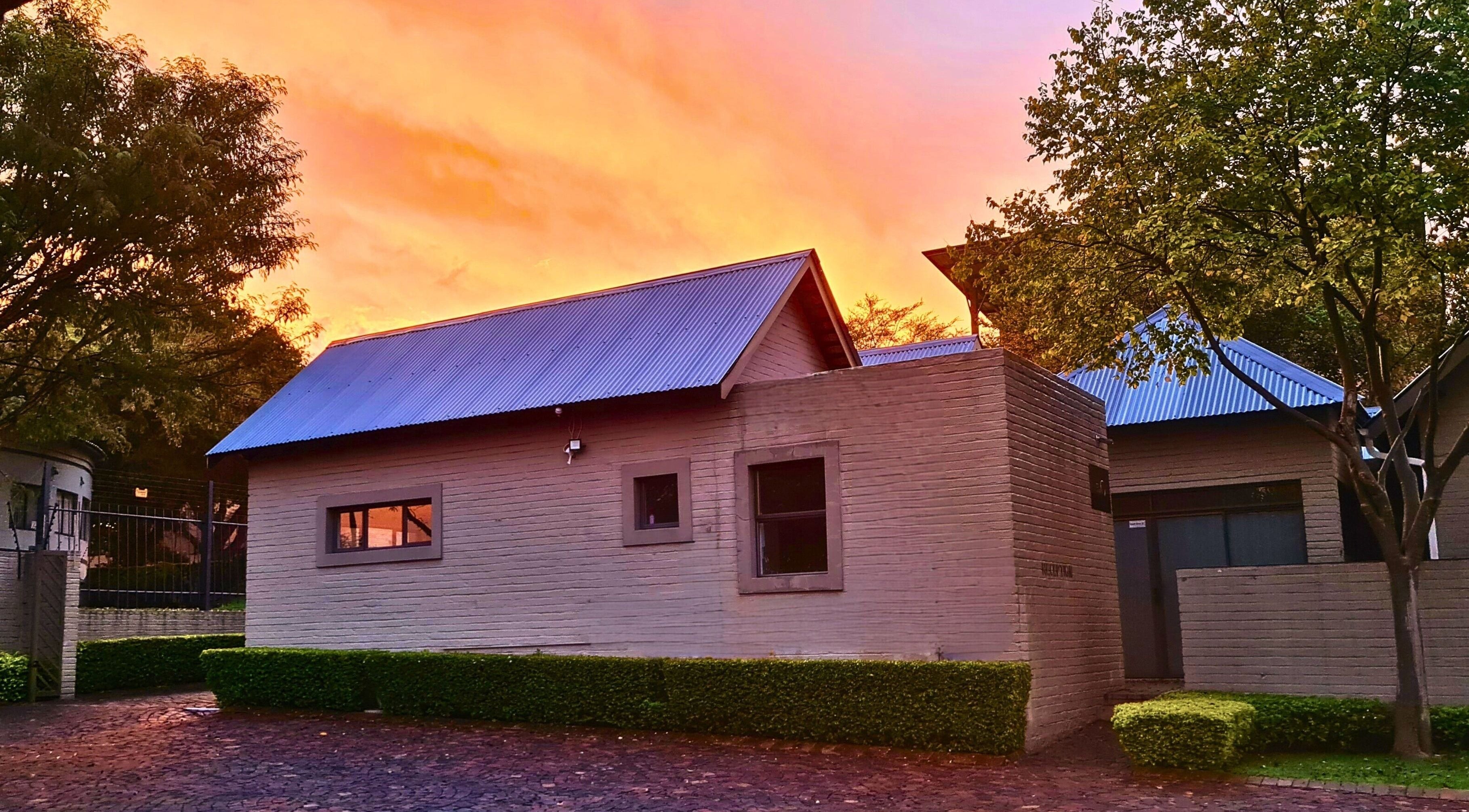 Elite Laser Aesthetics at sunset in Randburg, Gauteng, ZA, showcasing serene exterior and lush greenery.