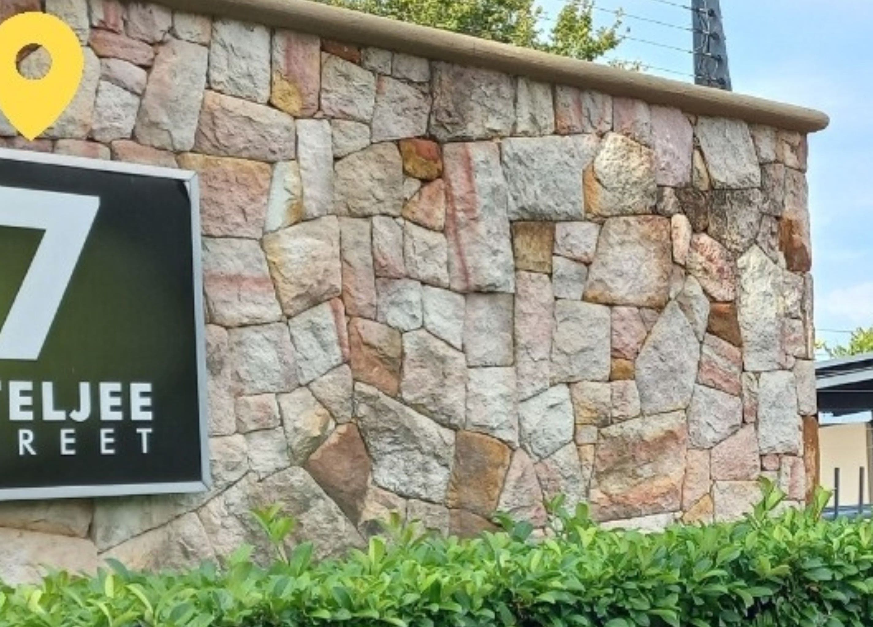 Entrance sign of Elite Laser Aesthetics at 7 Ateljee Street, Randburg, Gauteng, ZA showcased on a stone facade.