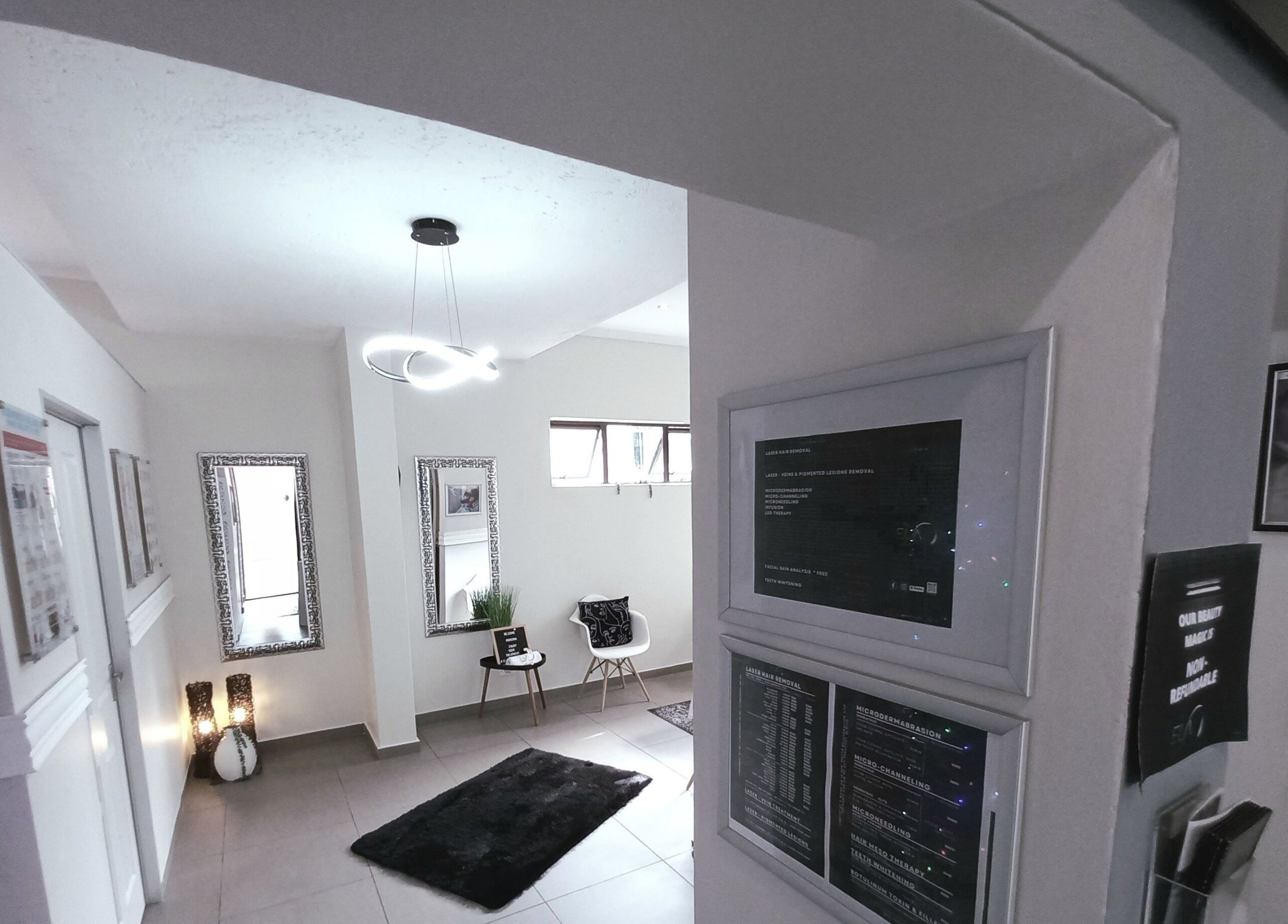 Entrance of Elite Laser Aesthetics, Randburg, Gauteng, ZA. Modern decor with mirrors and certificates.