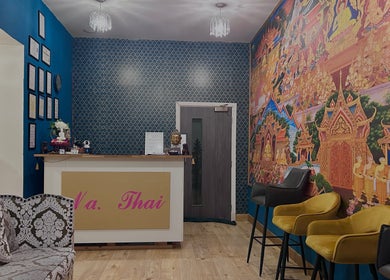 Reception at Na Thai Therapy, Birmingham, England, GB featuring vibrant Thai art and elegant seating.