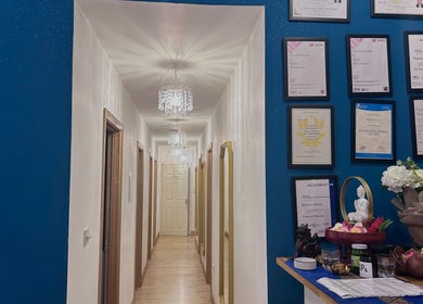 Elegant hallway at Na Thai Therapy, Birmingham, England, GB, adorned with crystal lights and floral décor.