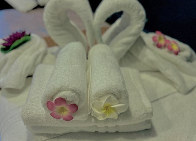Elegant towel arrangement with floral accents at Na Thai Therapy, Birmingham, England, GB.