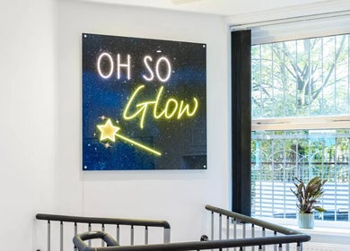 Neon Oh So Glow sign and plant by window in Halifax, England, GB. Bright, inviting venue decor.