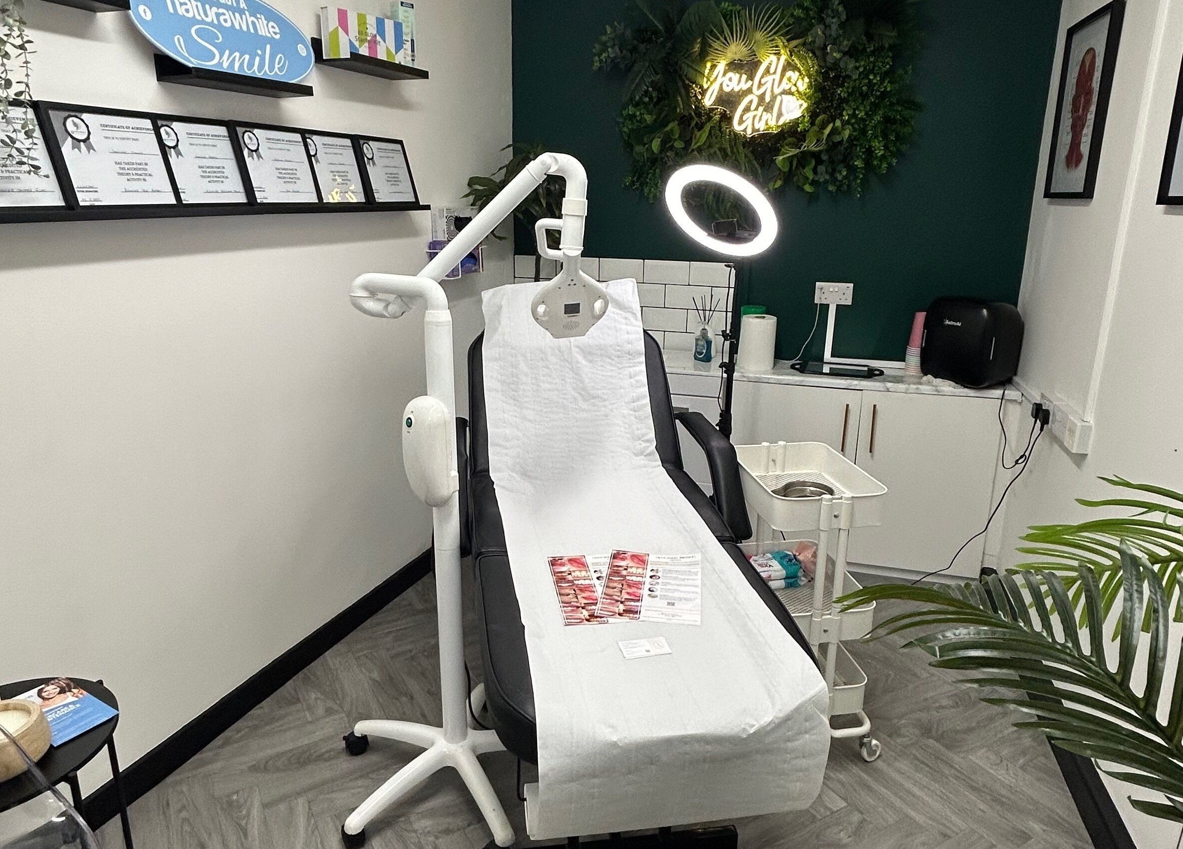Spa treatment room at Black & Bamber in Hull, England, GB with a modern chair and certificates on the wall.