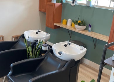 Chic wash station at The Copper Moss in Haysville, Kansas, US with elegant sinks and greenery.