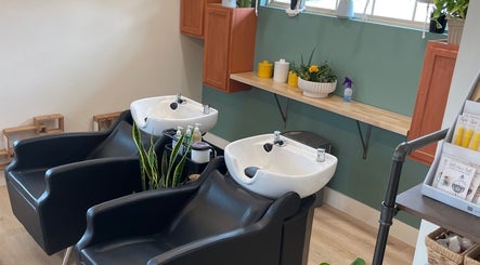 Chic wash station at The Copper Moss in Haysville, Kansas, US with elegant sinks and greenery.