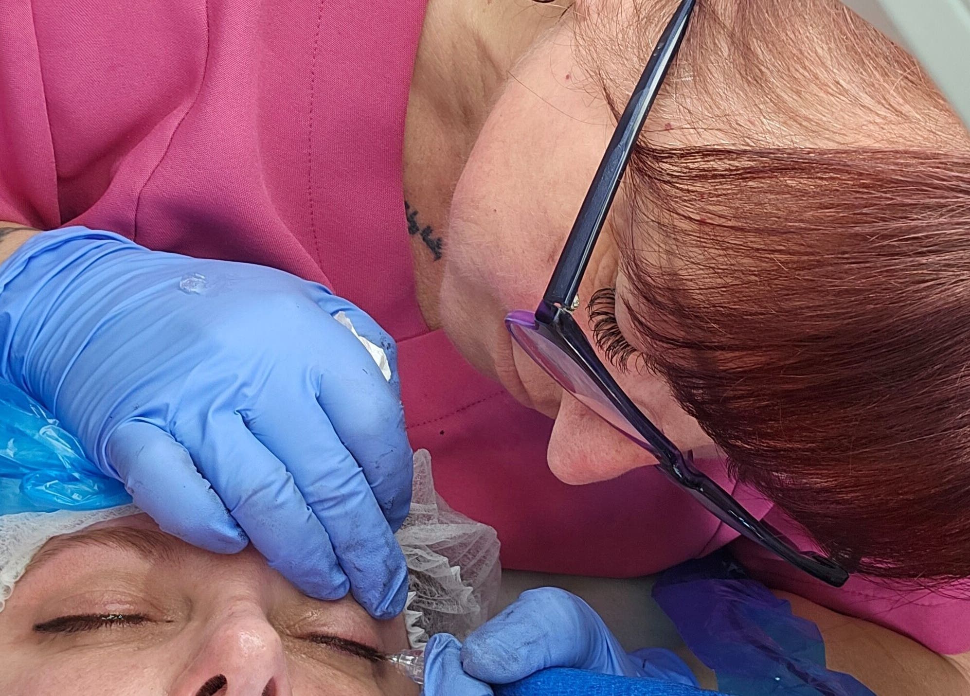 Professional eyebrow treatment at Skin-Finity, Aylesham, England, GB with artist in pink precision touch.