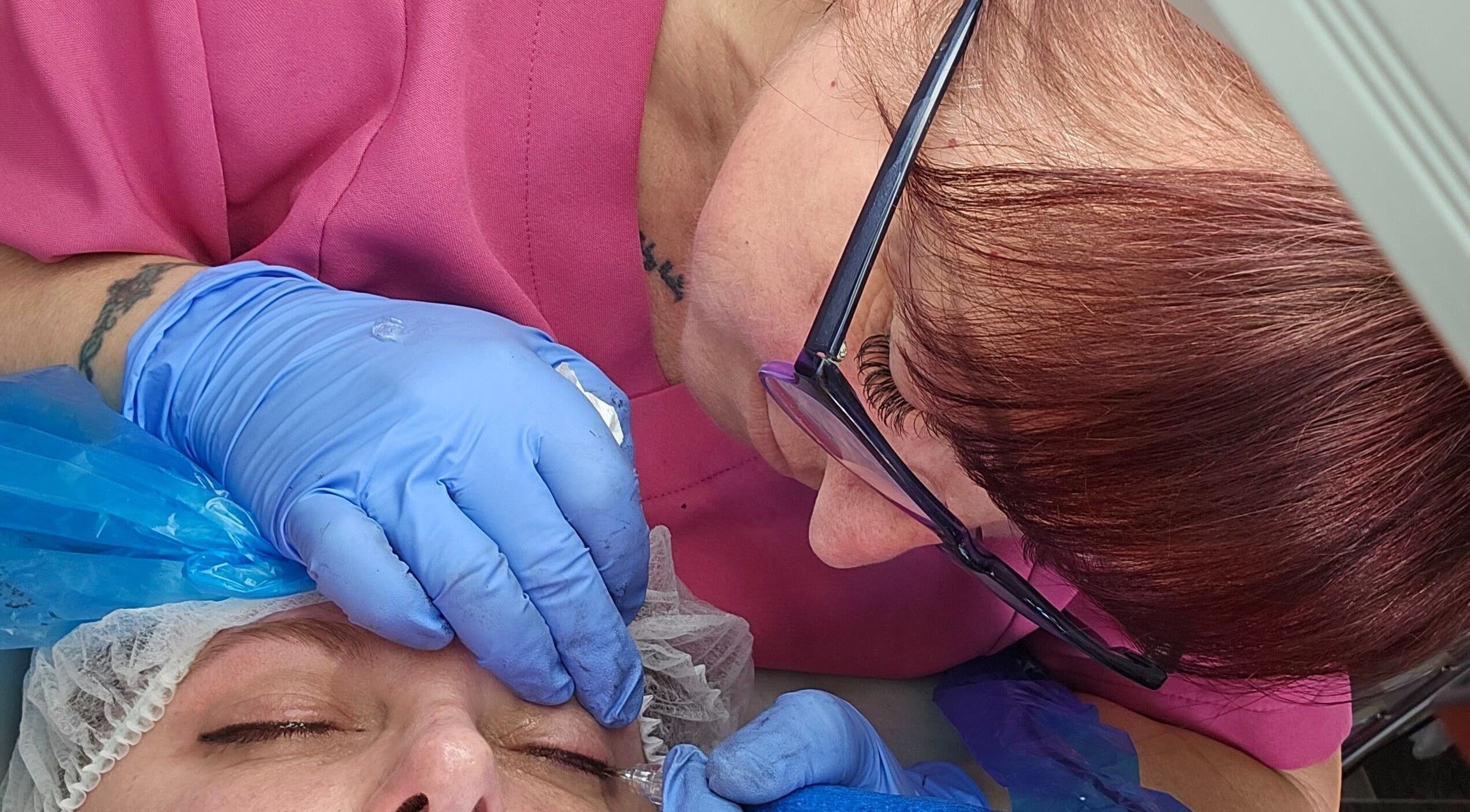 Professional eyebrow treatment at Skin-Finity, Aylesham, England, GB with artist in pink precision touch.