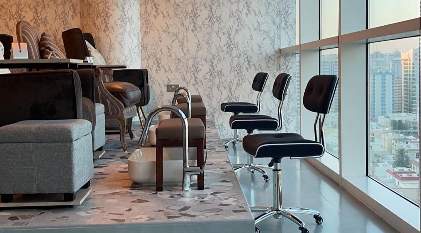 Luxurious pedicure station at Bel Fiore Ladies Salon, Abu Dhabi, featuring modern chairs and city views.