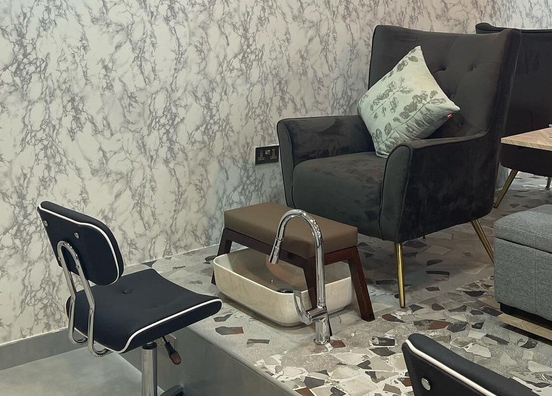 Relaxing pedicure lounge at Bel Fiore Ladies Salon, Abu Dhabi, AE with plush chairs and marble decor.