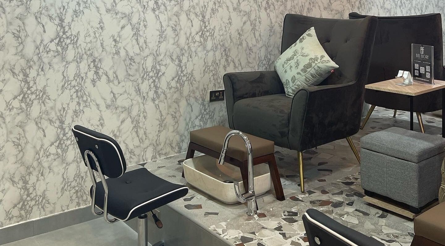 Relaxing pedicure lounge at Bel Fiore Ladies Salon, Abu Dhabi, AE with plush chairs and marble decor.
