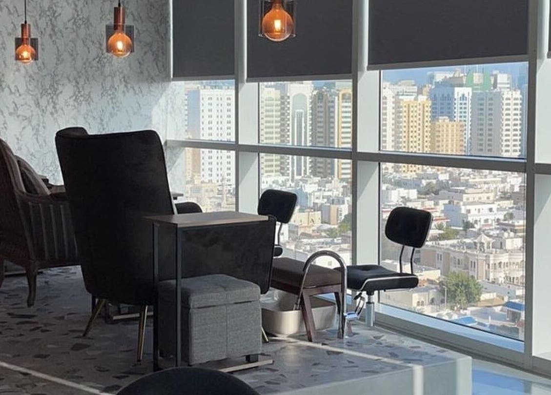 Luxurious city view from Bel Fiore Ladies Salon, Abu Dhabi, AE. Elegant chairs near large windows.