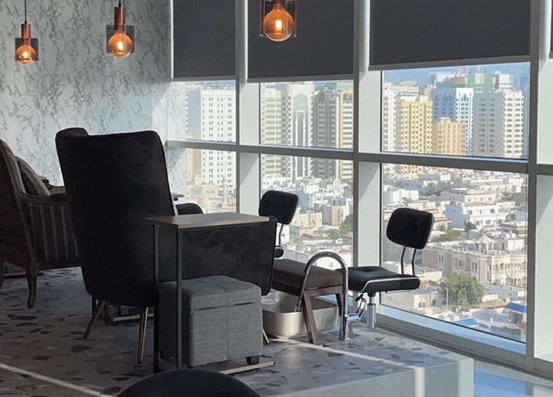 Luxurious city view from Bel Fiore Ladies Salon, Abu Dhabi, AE. Elegant chairs near large windows.