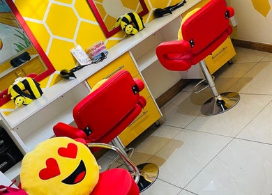 Bee2 Kids Salon in Kempton Park, Gauteng, ZA features vibrant red chairs and fun bee decor for children.