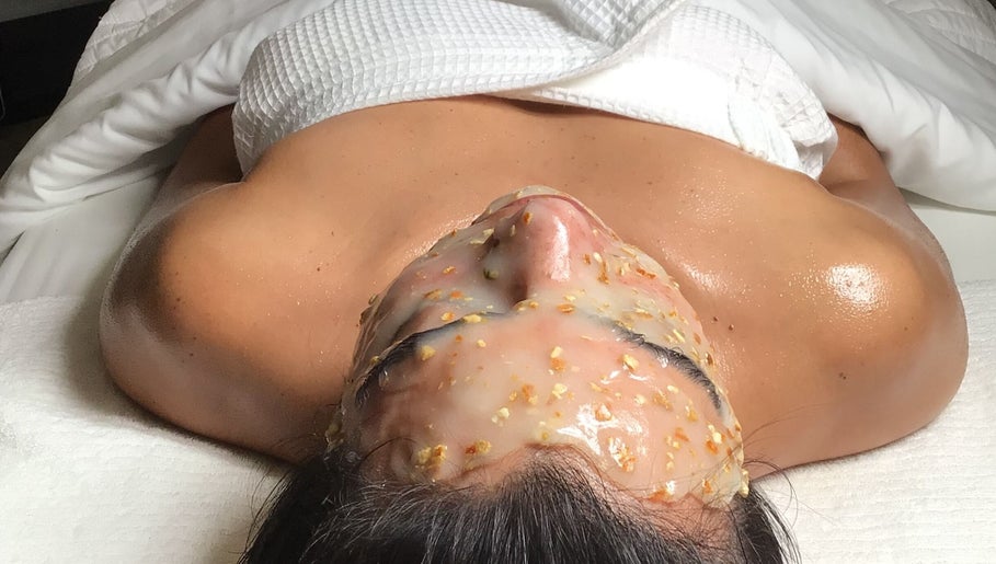 Relaxing facial treatment at The Glow Box Aesthetics in West Allis, Wisconsin, US, featuring exfoliating mask.