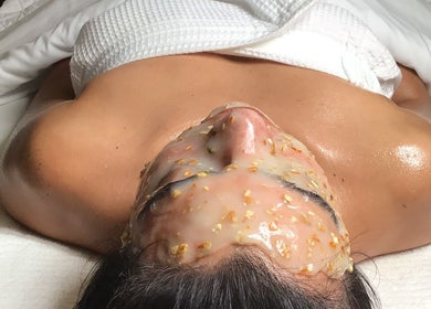 Relaxing facial treatment at The Glow Box Aesthetics in West Allis, Wisconsin, US, featuring exfoliating mask.