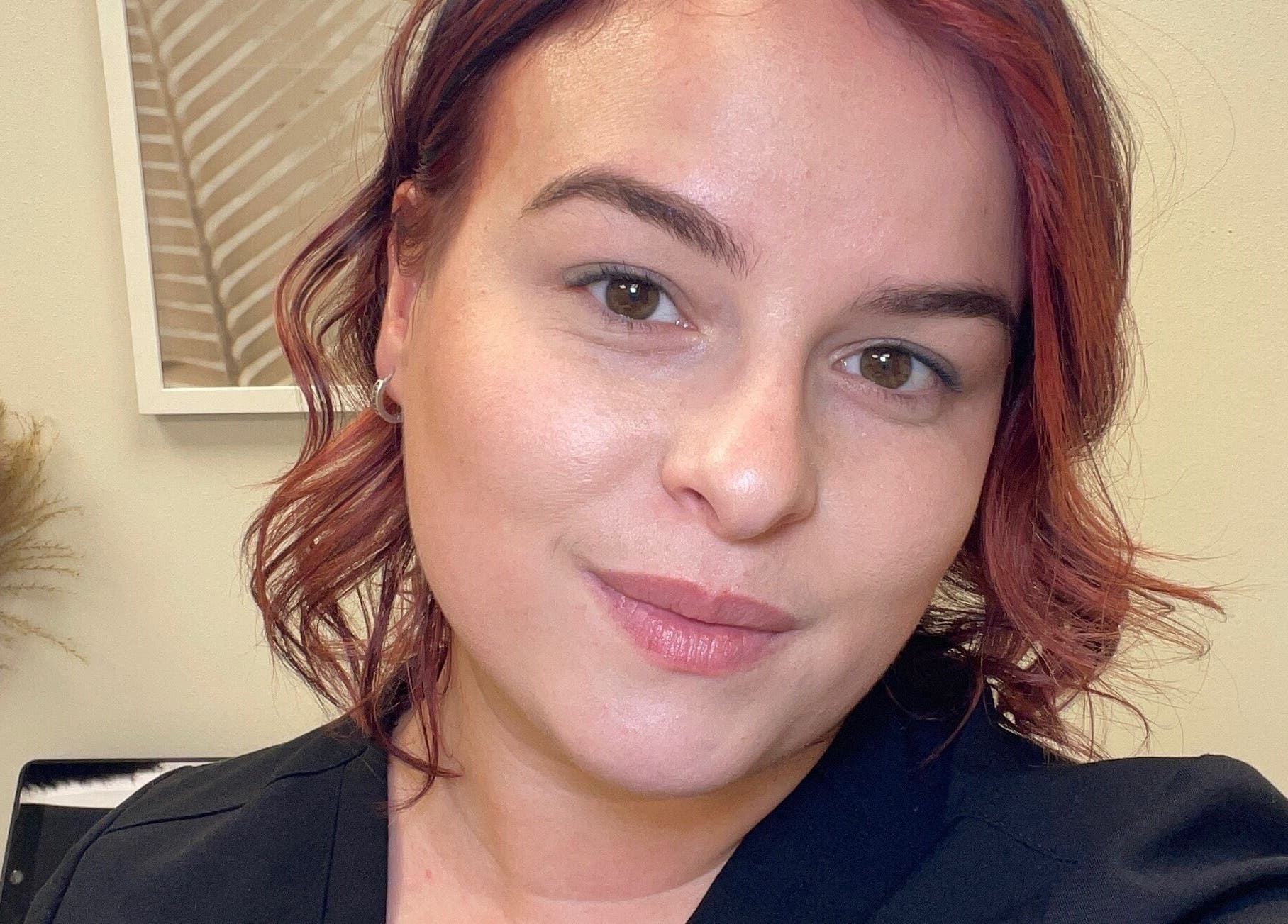 Smiling professional at The Glow Box Aesthetics in West Allis, Wisconsin, US showcasing welcoming ambiance.