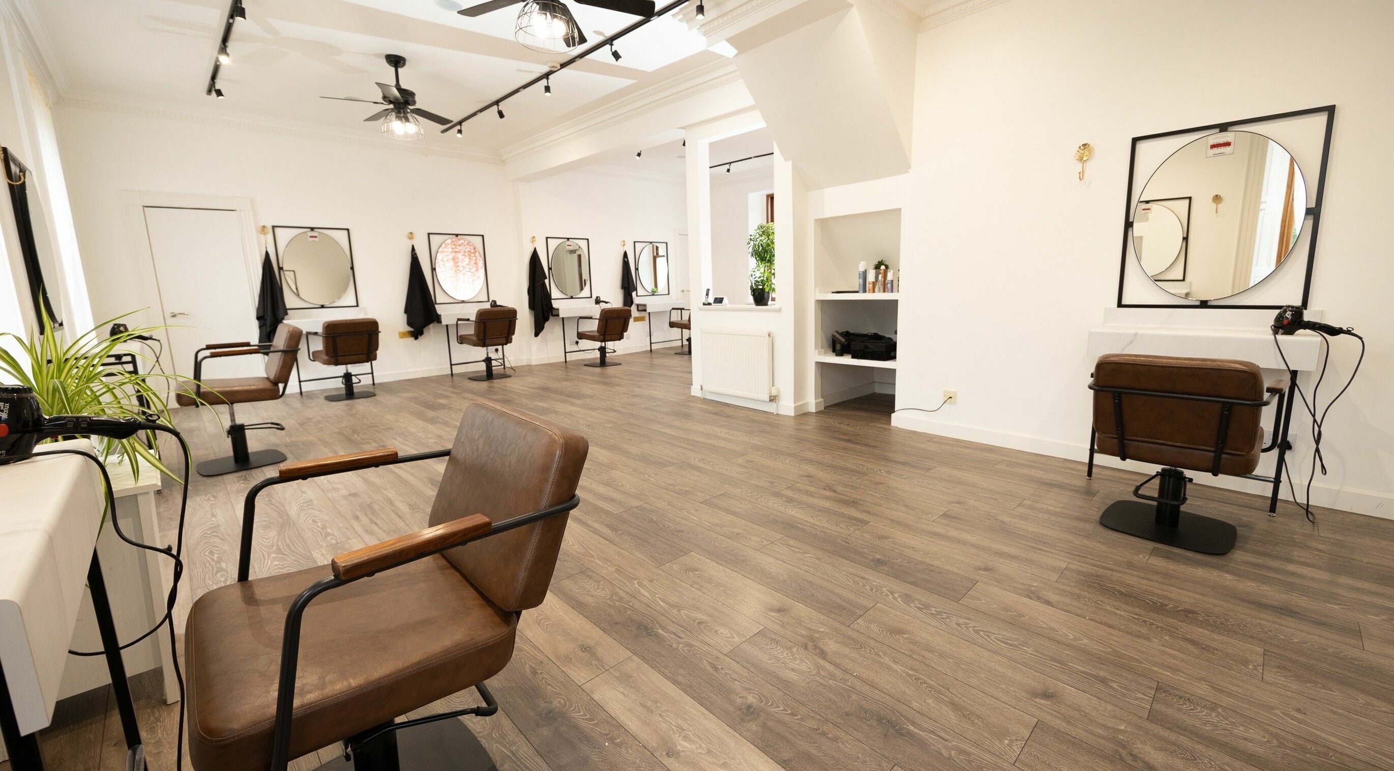 Spacious salon interior with styling chairs at The House of Hair, Aberdeen, Scotland, GB.