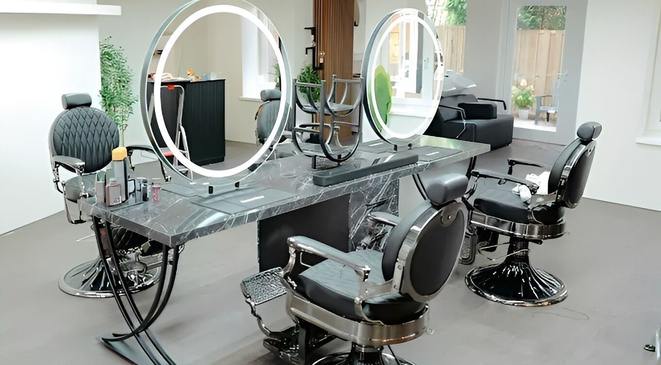 Modern barber chairs at Icon Barbershop Amsterdam, Noord-Holland, NL, with sleek design and mirrors.
