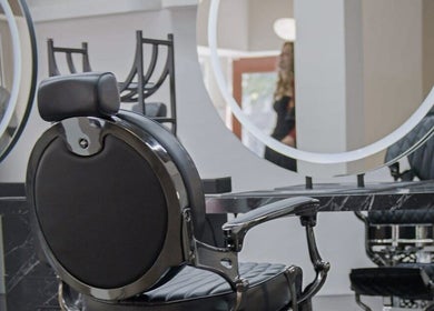 Modern barber chair and mirrors at Icon Barbershop Amsterdam, Noord-Holland, NL.