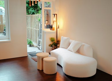 Elegant lounge area at Icon Barbershop Amsterdam, Amsterdam, Noord-Holland, NL, with modern white furniture.