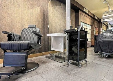 Modern barber chair at Prime Barbershop Amsterdam, Noord-Holland, NL, showcasing sleek interior design.