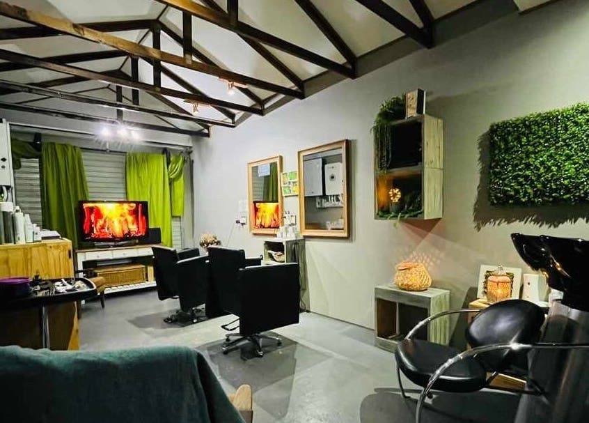Chic interior of Authentic Cutz By Bernice in Gqeberha, Eastern Cape, ZA featuring elegant chairs and green decor.
