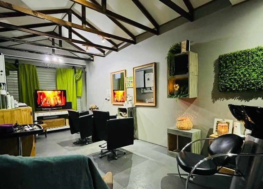 Chic interior of Authentic Cutz By Bernice in Gqeberha, Eastern Cape, ZA featuring elegant chairs and green decor.