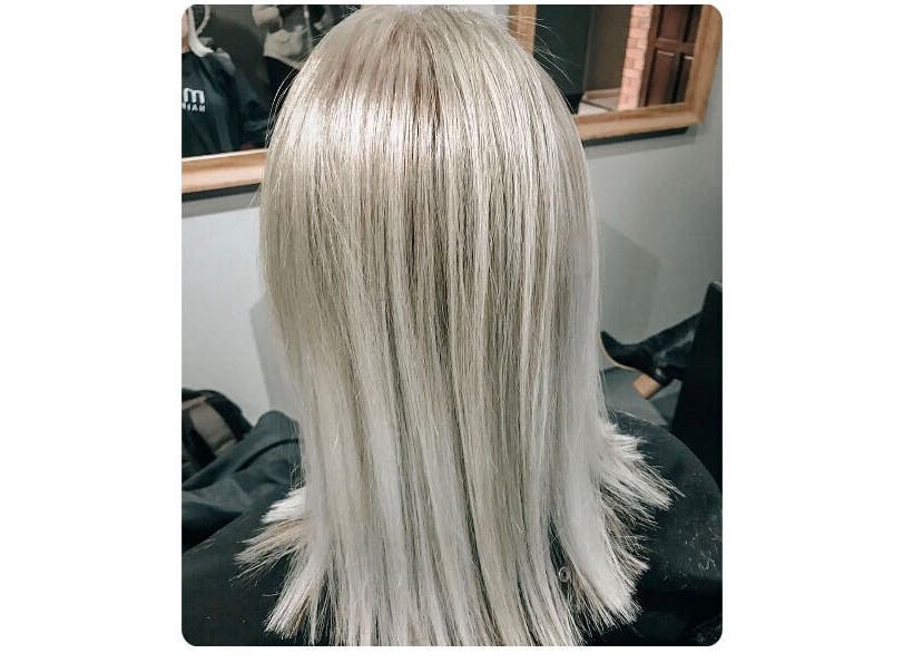 Elegant silver hair styled at Authentic Cutz By Bernice, Gqeberha, Eastern Cape, ZA, showcasing sleek look.