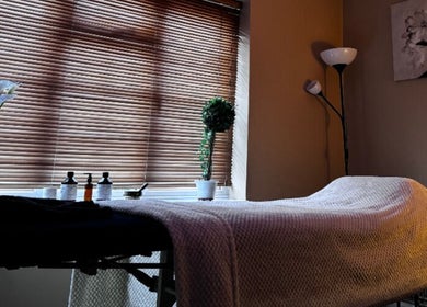 Relaxing therapy room at Alma Wellness, West Wickham, England, GB with massage table and ambient lighting.