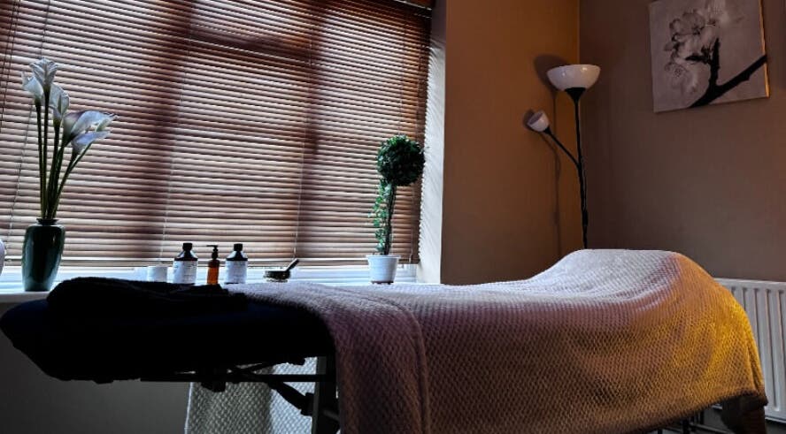 Relaxing therapy room at Alma Wellness, West Wickham, England, GB with massage table and ambient lighting.