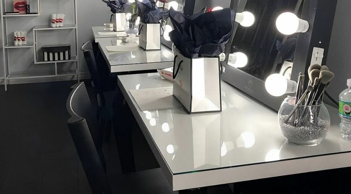 Elegant makeup stations at Selfish Beauty Lounge in Vaughan, Ontario, CA, featuring illuminated mirrors and tools.