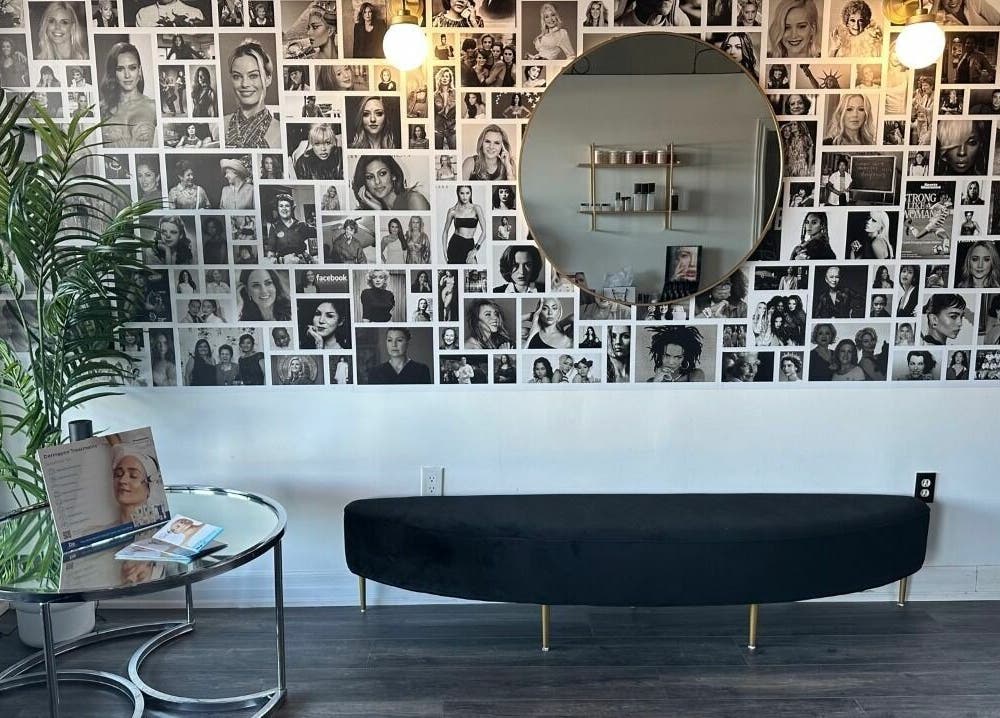 Modern lounge area at Selfish Beauty Lounge, Vaughan, Ontario, CA with photo collage and stylish seating.