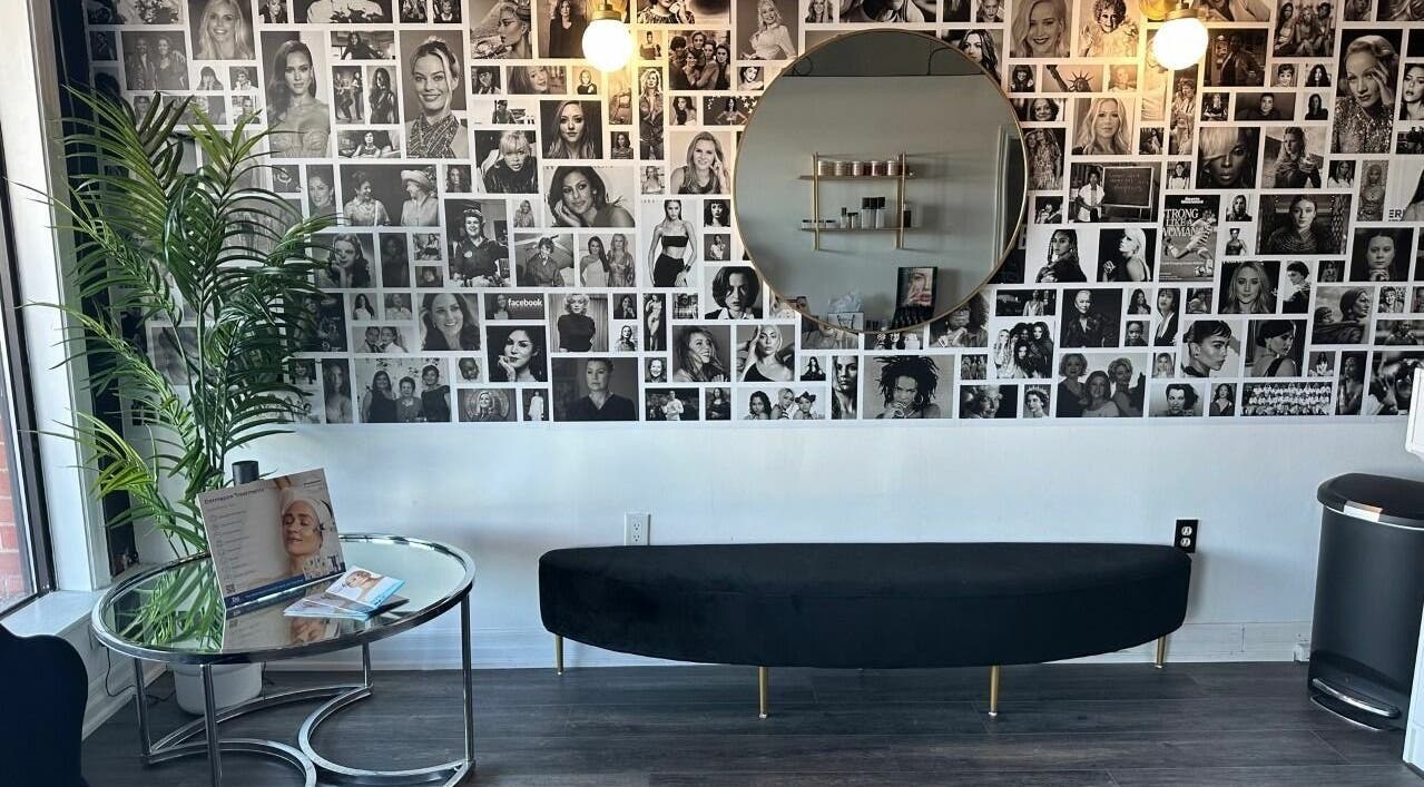 Modern lounge area at Selfish Beauty Lounge, Vaughan, Ontario, CA with photo collage and stylish seating.