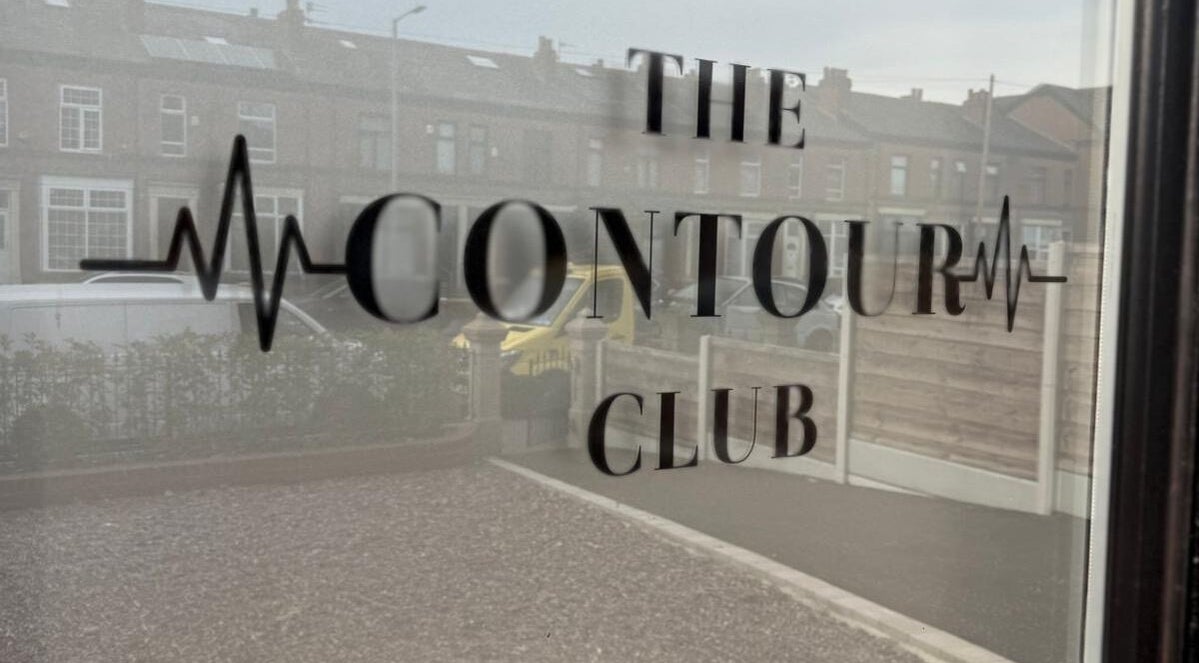 Window with The Contour Club Mcr logo in Bolton, England, GB.