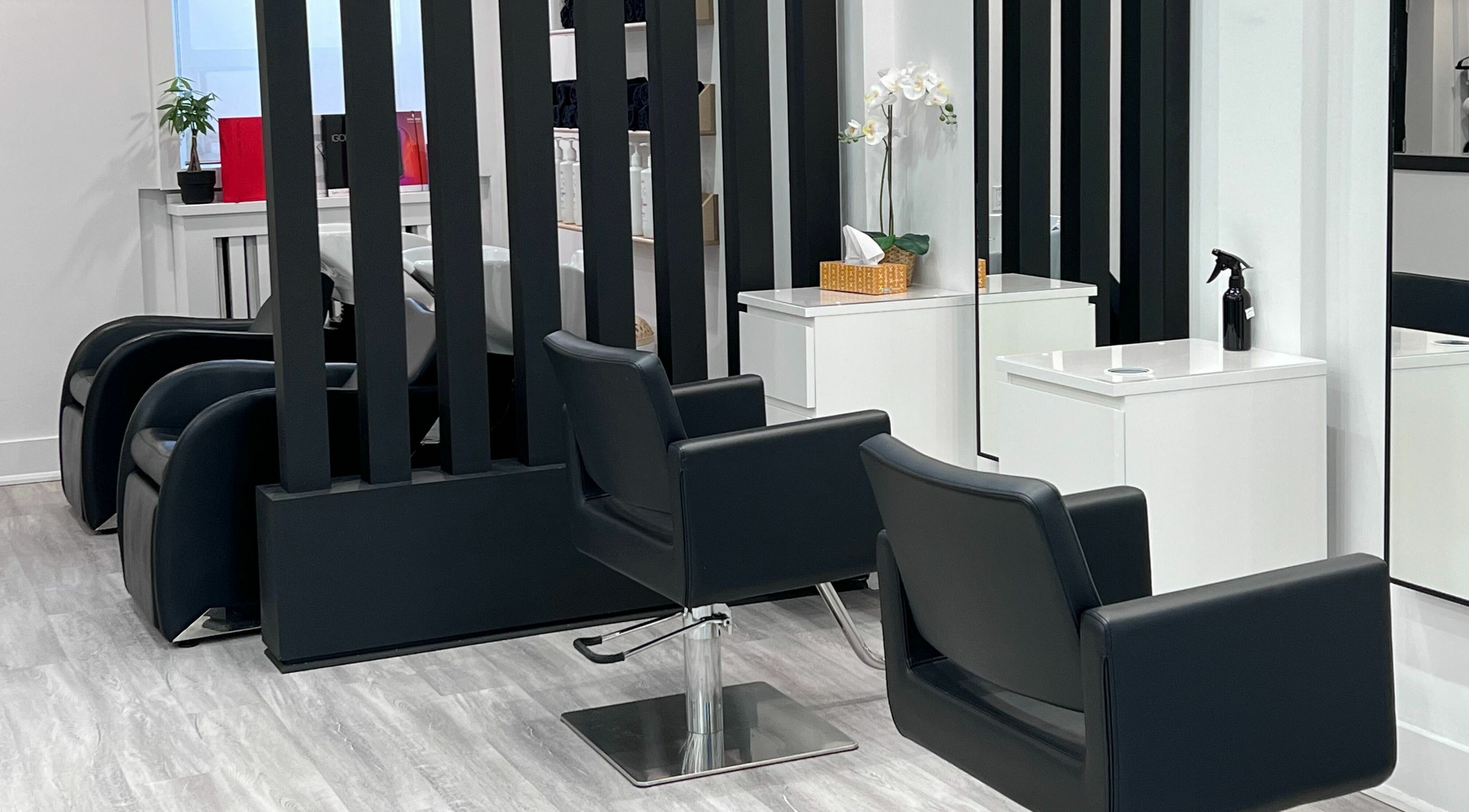 Modern salon interior at Nerses Hair Salon, Toronto, Ontario, CA with sleek black chairs and bright decor.