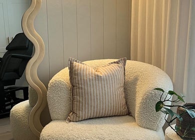 Inviting seating area at Simmy & Co Nails, Melbourne, Victoria, AU with plush chair and decorative pillow.