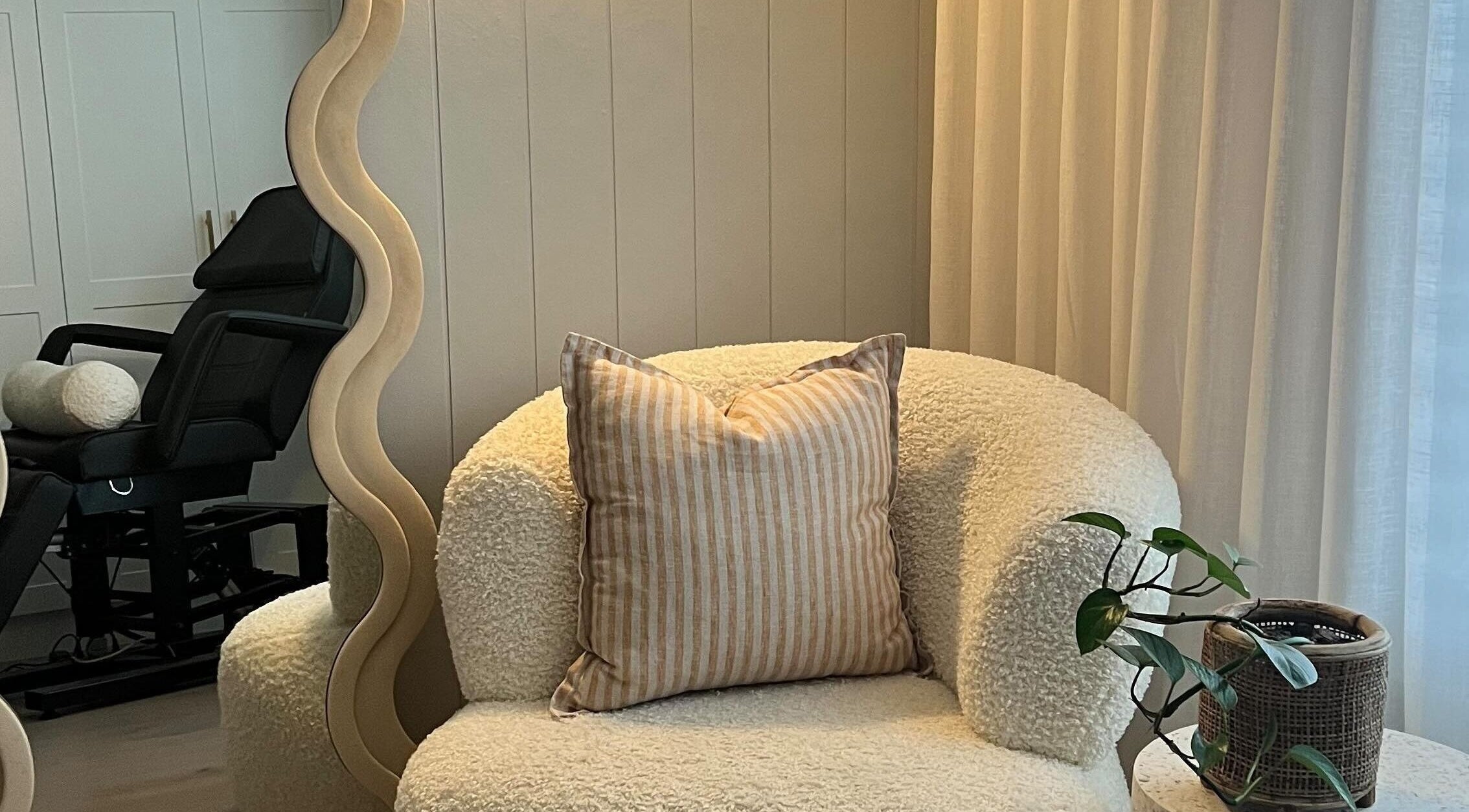 Inviting seating area at Simmy & Co Nails, Melbourne, Victoria, AU with plush chair and decorative pillow.