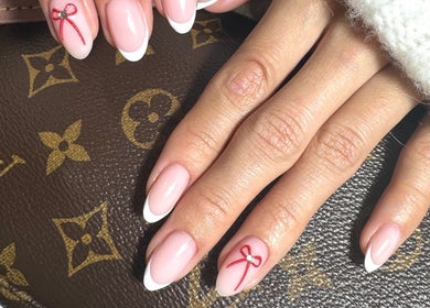 French manicure with red bow designs at Simmy & Co Nails, Melbourne, Victoria, AU.